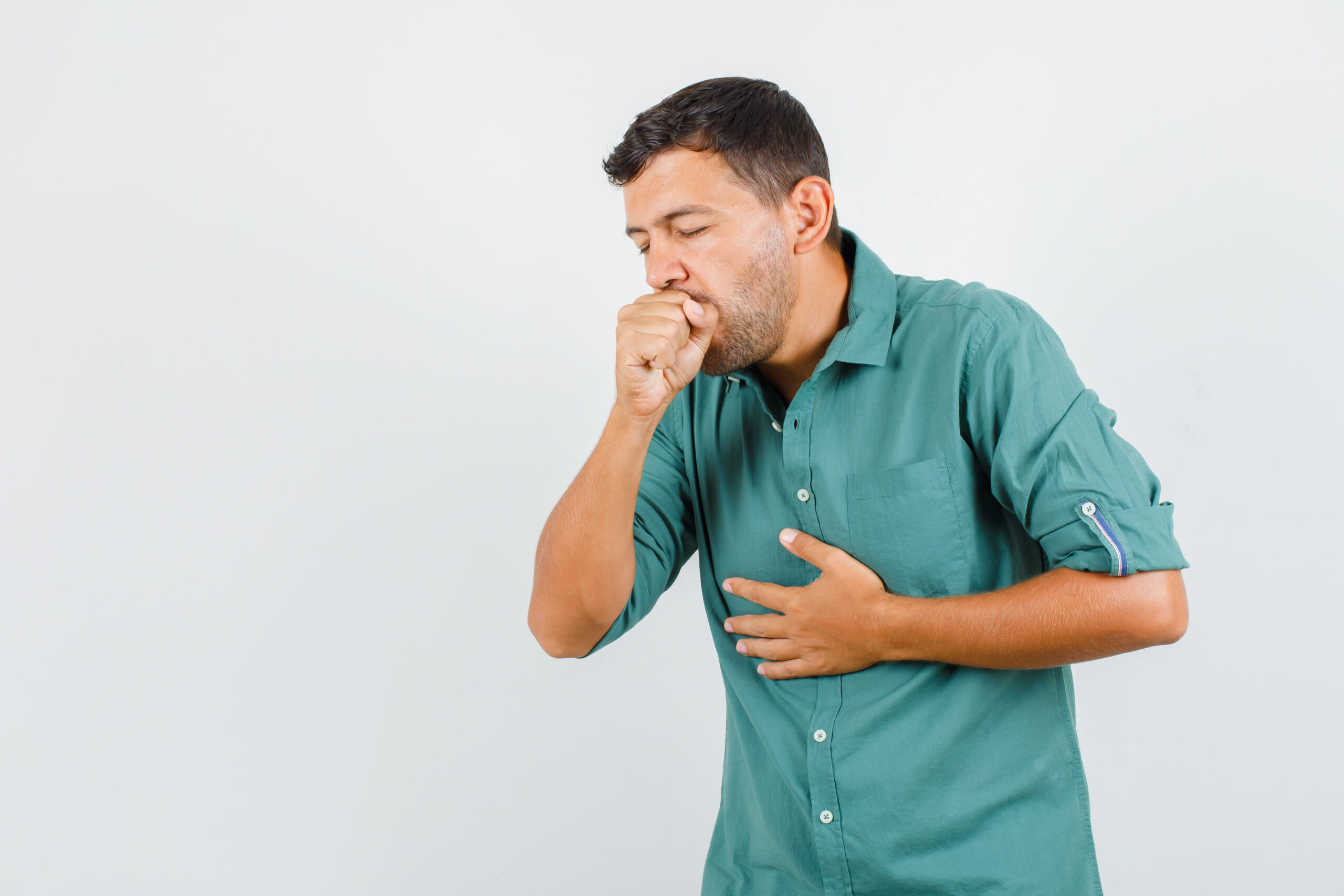 Young man suffering from cough in shirt and looking ill. front view.